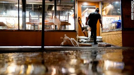 Thursday, people like Konrad Karandy started preparing for potential historic tidal flooding by placing sandbags in front of businesses in Annapolis, Maryland. 