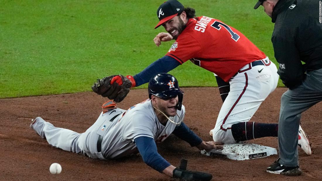 The Astros&#39; Jose Siri is safe at second after the Braves shortstop Dansby Swanson missed the throw during the eighth inning.
