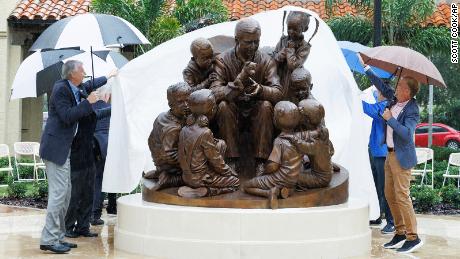 A statue honoring TV host Fred Rogers is unveiled on Thursday at Rollins College.