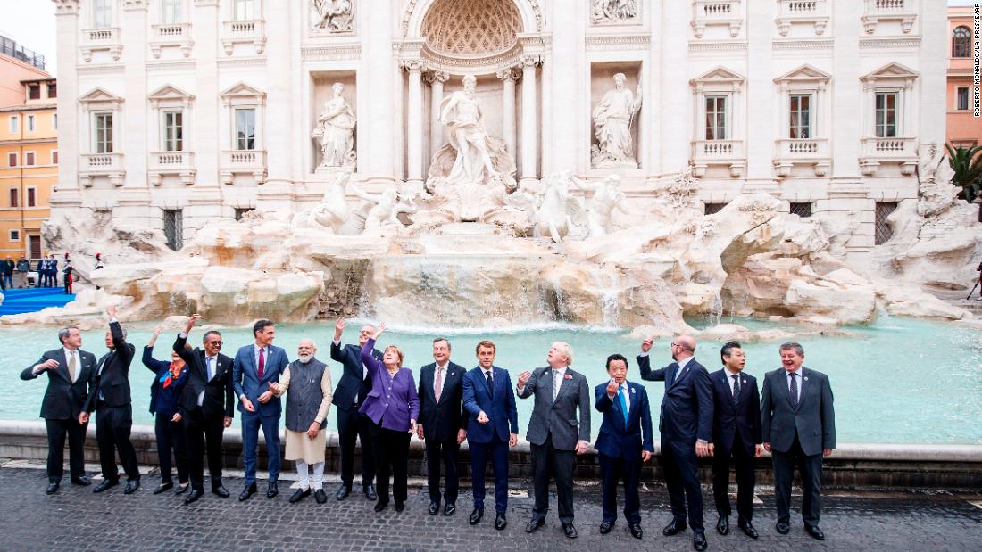 World leaders throw coins into the Trevi Fountain during the G20 summit on Sunday.