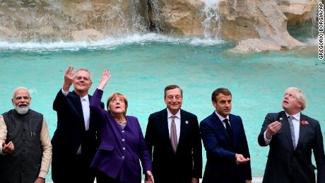 G20 leaders from left, India&#39;s Prime Minister Narendra Modi, Australia&#39;s Prime Minister Scott Morrison, German Chancellor Angela Merkel, Italy&#39;s Prime Minister Mario Draghi, French President Emmanuel Macron and British Prime Minister Boris Johnson perform the traditional coin toss in front of the Trevi Fountain during an event for the G20 summit in Rome, Sunday, October 31, 2021.