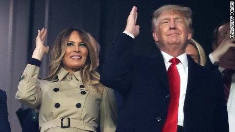 Former first lady and president of the United States Melania and Donald Trump do the &quot;Tomahawk chop&quot; prior to Game Four of the World Series between the Houston Astros and the Atlanta Braves on Saturday at Truist Park in suburban Atlanta.