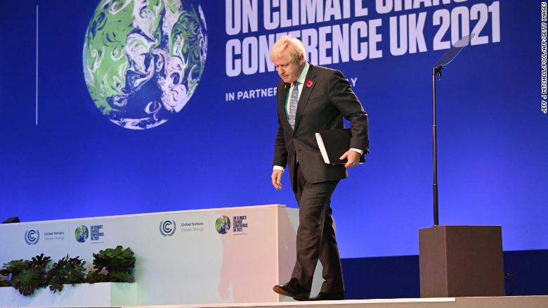 Britain&#39;s Prime Minister Boris Johnson walks off of the stage after speaking at COP26 on Monday.