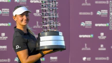 Danish golfer Emily Kristine Pedersen celebrates with the trophy after winning the Saudi Ladies International golf tournament on November 15, 2020, at the King Abdullah Economic City, north of Jeddah. (Photo by Amer HILABI / AFP) (Photo by AMER HILABI/AFP via Getty Images)