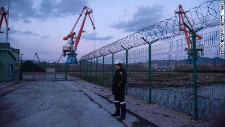 A Russian worker near a coal port at the Rason Special Economic Zone, established by North Korea, where a mountain of North Korean coal lies stranded by UN sanctions on coal exports, in November 2017.