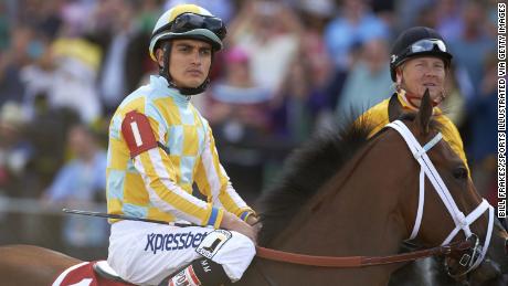 Miguel Mena (L) aboard Bayern before the 139th Preakness Stakes race at Pimlico Race Course in 2014.
