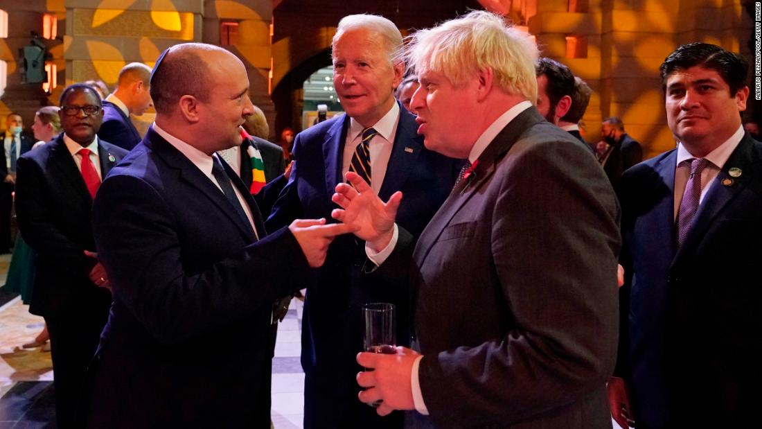 Biden chats with Israeli Prime Minister Naftali Bennett, left, and British Prime Minister Boris Johnson during an evening reception on Monday.