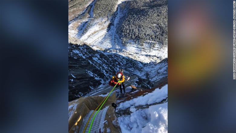 Rescuers save dangling BASE jumper after he slammed into a cliff and his parachute got stuck on a rock