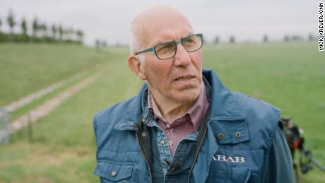 Nol Hooijmaijers stands next to the mound on which his dairy farm was rebuilt. Starting in 2010, Dutch authorities removed the dike that protected this spit of land from the Bergse Maas river, allowing the farmland to flood when the river swells.