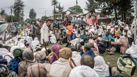 People in a temporary internally displaced people (IDP) camp receive their first bags of wheat from the World Food Programme in Debark, Ethiopia, on September 15.