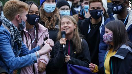 Greta Thunberg, surrounded by other climate protesters on Monday