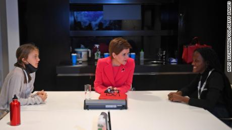 Scottish Prime Minister Nicola Sturgeon, center, talks to climate activist Vanessa Nakate, right, and Greta Thunberg, left, during the COP26 conference.