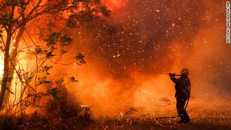 A firefighter battles flames in Cordoba, Argentina, in October 2020. Wildfires have destroyed thousands of hectares in the Argentine province of Cordoba this year, amid a drought and high temperatures.