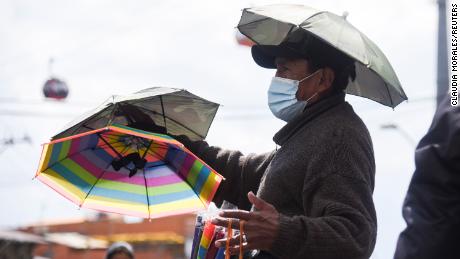 A vendor sells umbrella hats amid an unusual heatwave in La Paz, Bolivia. The high-altitude Andean regions of South America can be hit by some of the most dangerous levels of UV radiation in the world.