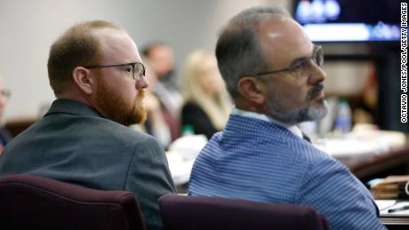 Travis McMichael, left, listens to opening statements with one of his attorneys on November 5, 2021 in Brunswick, Georgia.