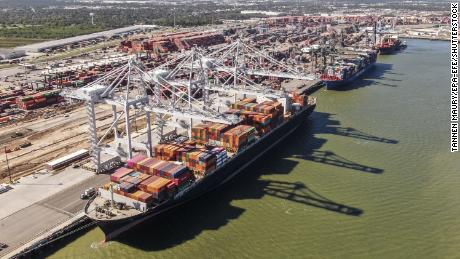 An aerial photo shows container ships at a port in Houston.