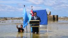 Tuvalu&#39;s Minister recorded a COP 26 message in knee-deep seawater to highlight the real-life impact of climate change in their country.