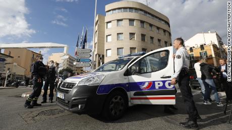 French police officers stand at a security perimeter following a knife attack in Cannes, France on Monday.