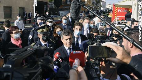 France&#39;s Interior Minister Gerald Darmanin, center, speaks to the press near the Cannes police station.