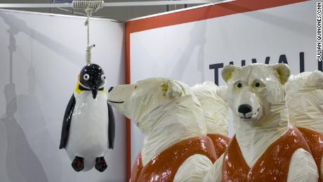 Tuvalu&#39;s booth at COP26 includes a sculpture by eco-artist Vincent Huang that features polar bears in life jackets and a penguin hanging by a noose.