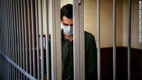 US ex-marine Trevor Reed, charged with attacking police, stands inside a defendants&#39; cage during his verdict hearing at Moscow&#39;s Golovinsky district court on July 30, 2020. 