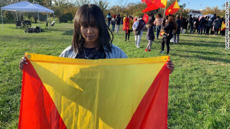 Su Solo holds the flag of Tigray, the northern Ethiopian region where her mom lives. She says they haven&#39;t spoken in months due to a communications blackout.