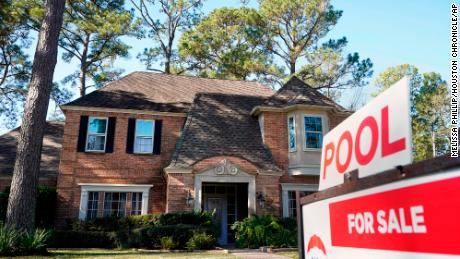 In this Wednesday, Jan. 13, 2021, file photo, a real estate sign is shown at a home for sale, in Houston. 