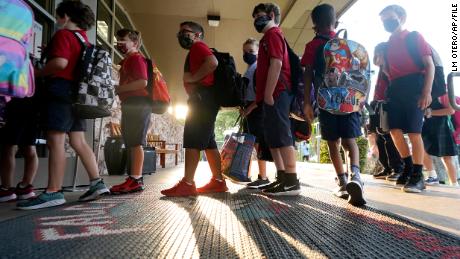 Students at the Richardson Independent School District in Texas line up for the first day of class on August 17, 2021. The district has required masks despite the governor&#39;s executive order.