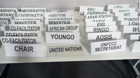 Department and position name plates are laid out ahead of a meeting at the COP26 climate summit.