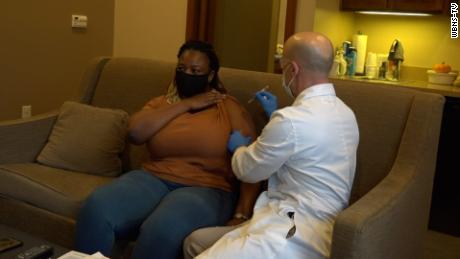 With tears in her eyes, Lorraine Charinda receives her second Covid vaccine on Wednesday.