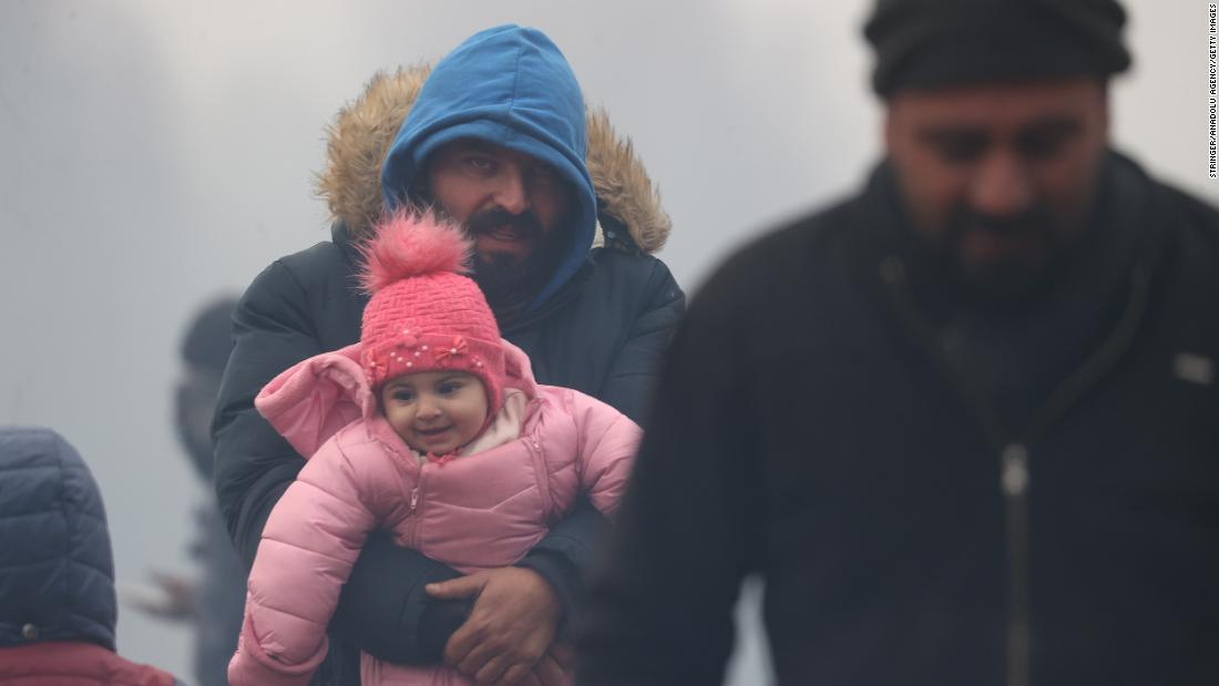 Migrants wait near the border crossing on Wednesday, November 10.