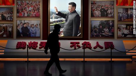 A man walks in front of a picture of China&#39;s President Xi Jinping at the Museum of the Communist Party of China in Beijing on November 11, 2021. (Photo by Noel Celis / AFP) (Photo by NOEL CELIS/AFP via Getty Images)