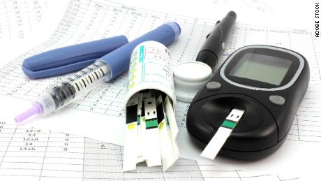 A typical glucometer, test strips, and insulin syringe used to manage diabetes.