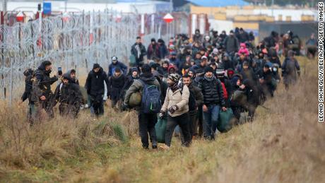 A group of migrants walk along the Belarusian-Polish border in Belarus&#39; Grodno region on November 12, 2021. 