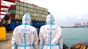 QINGDAO, CHINA - NOVEMBER 7, 2021 - Two policemen patrol beside cargo ships at the Huangdao Entry-exit border inspection station at Qingdao Port&#39;s foreign trade container terminal in East China&#39;s Shandong province, Nov. 7, 2021. The value of China&#39;s imports and exports rose 22.2 percent year-on-year in the first 10 months of this year. (Photo credit should read Yu Fangping / Costfoto/Barcroft Media via Getty Images)