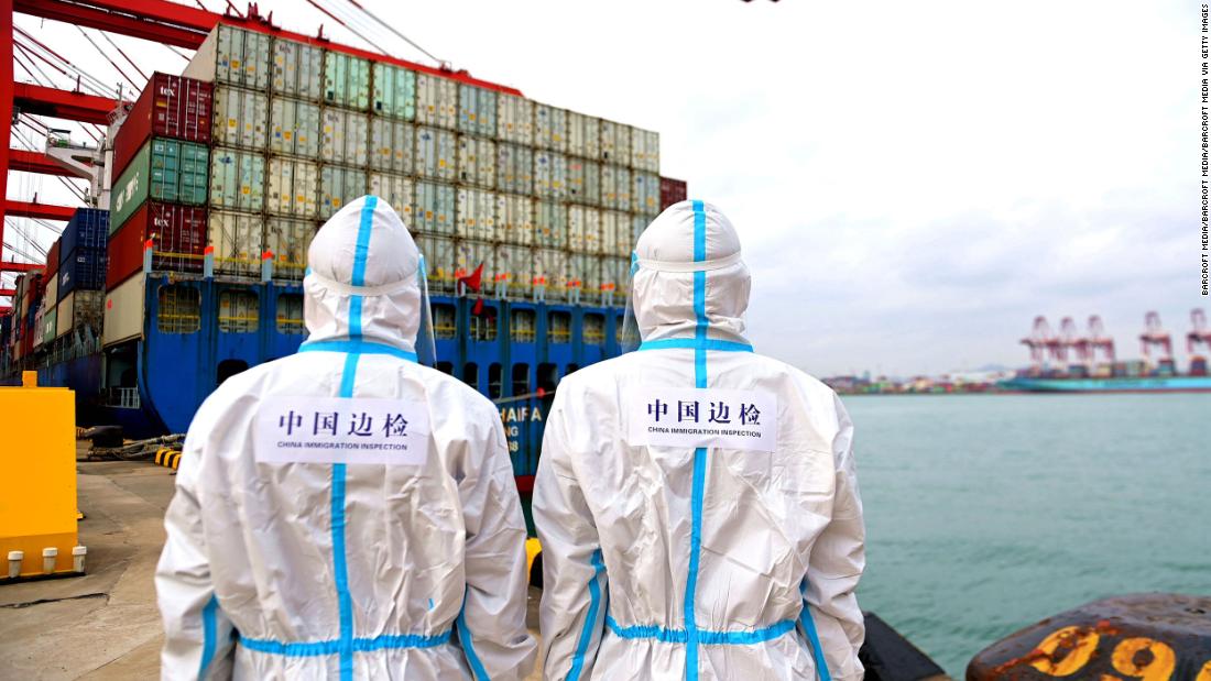 Two policemen patrol at the Huangdao border inspection station at Qingdao Port&#39;s foreign trade container terminal in China&#39;s Shandong province on November 7.