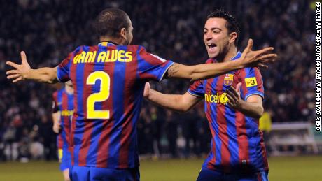 Xavi celebrates with Alves after scoring Barcelona&#39;s first goal in the La Liga match between Valladolid and Barcelona on January 23, 2010.