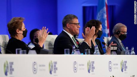 Britain&#39;s Alok Sharma, second left, President of the COP26 and Patricia Espinosa, left, UNFCCC Executive-Secretary applaud during the closing plenary session at the COP26 UN Climate Summit, in Glasgow, Scotland, Saturday, Nov. 13, 2021