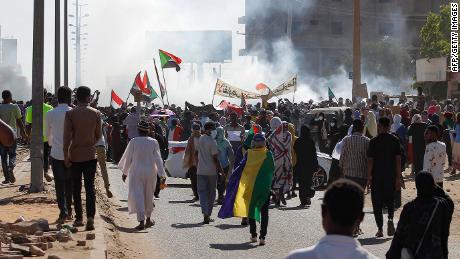 Sudanese opponents of the military coup wave national flags as they take part in a protest in the city of Khartoum North near the capital, on November 13, 2021.