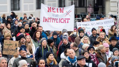A demonstrator holds a placard reading &#39;No to compulsory vaccination&#39; during an anti-vaccination protest at the Ballhausplatz in Vienna, Austria, on November 14, 2021, after a Corona crisis&#39; summit of the Austrian government. - Austrian Chancellor Alexander Schallenberg said on November 14, that a nationwide lockdown would begin on November 15, for those not vaccinated against Covid-19 or recently recovered, as the EU member fights a record surge in cases. - Austria OUT (Photo by GEORG HOCHMUTH / APA / AFP) / Austria OUT (Photo by GEORG HOCHMUTH/APA/AFP via Getty Images)
