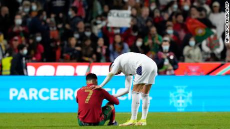 Cristiano Ronaldo is consoled by Filip Kostic after Portugal&#39;s defeat against Serbia. 