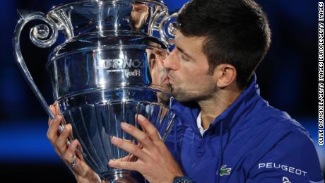 Novak Djokovic is presented with the trophy for ending the year as world No. 1.