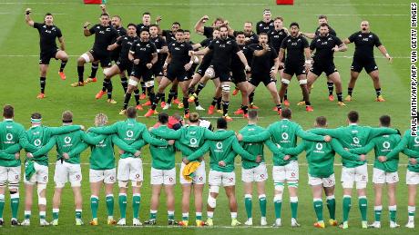 New Zealand's players (back) perform the haka as Ireland's players look on ahead of the Autumn International friendly rugby union match between Ireland and New Zealand at the Aviva Stadium in Dublin, on November 13, 2021. (Photo by PAUL FAITH / AFP) (Photo by PAUL FAITH/AFP via Getty Images)