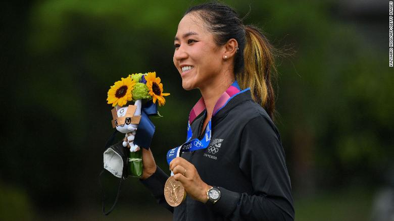 Ko poses with her bronze medal on the podium during the victory ceremony of the women&#39;s golf competition at the Tokyo 2020 Olympic Games.