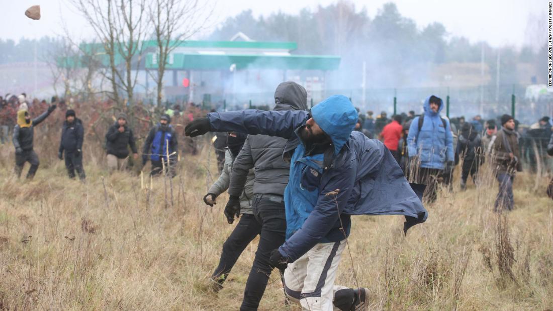 Migrants throw stones at Polish border guards at the Bruzgi-Kuznica border crossing on Tuesday, November 16.
