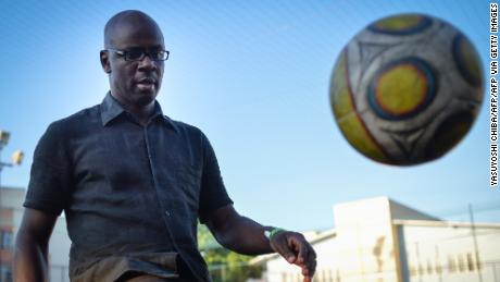 Former French football player Lilian Thuram controls the ball at a football field during his visit to Alemao shantytown complex in Rio de Janeiro, Brazil, on March 15, 2014. Llilian Thuram, winner of FIFA World Cup in 1998, and president of the Lilian Thuram Foundation aiming at education against racism, is in Rio on a week-long campaign of the Rio Art Museum (MAR).  AFP PHOTO / YASUYOSHI CHIBA        (Photo credit should read YASUYOSHI CHIBA/AFP via Getty Images)