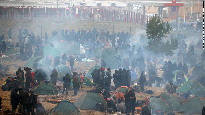 Smoke rises over a makeshift migrant camp on the Belarusian side of the border near Bruzgi.