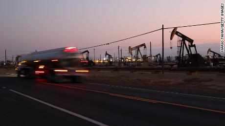 A truck passes pumpjacks in the Belridge oil field on November 03, 2021 near McKittrick, California. 