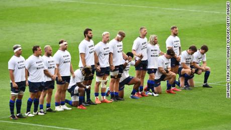 Some Sale Sharks players take a knee and some stand ahead of the side&#39;s game against Exeter last year.