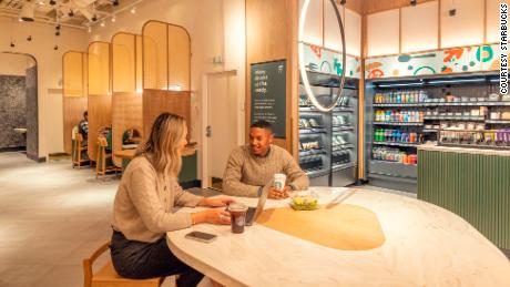 People sit at a table in the Starbucks Amazon Go store. 